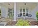 Inviting front porch featuring stone flooring, stylish seating, and attractive landscaping at 332 Aster Ridge Trl, Peachtree City, GA 30269