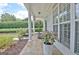 Charming front porch with flagstone flooring, white columns, and a view of the manicured lawn at 332 Aster Ridge Trl, Peachtree City, GA 30269