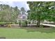 Inviting front yard features a well-kept lawn and mature trees surrounding a charming home at 332 Aster Ridge Trl, Peachtree City, GA 30269