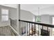 Hallway with black metal banister overlooking the living room at 332 Aster Ridge Trl, Peachtree City, GA 30269