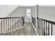 Hallway with black metal banister and hardwood flooring at 332 Aster Ridge Trl, Peachtree City, GA 30269