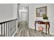 Hallway featuring hardwood flooring and elegant table with decorative accents at 332 Aster Ridge Trl, Peachtree City, GA 30269