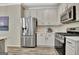 Stainless steel refrigerator and appliances with white cabinets and subway tile backsplash at 332 Aster Ridge Trl, Peachtree City, GA 30269