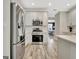 Bright kitchen features stainless steel appliances and white cabinets with view to dining area at 332 Aster Ridge Trl, Peachtree City, GA 30269
