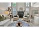 Bright living room with a fireplace, modern chairs, and large windows at 332 Aster Ridge Trl, Peachtree City, GA 30269