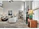 Open-concept living room with a vaulted ceiling and a cozy fireplace at 332 Aster Ridge Trl, Peachtree City, GA 30269