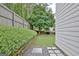 A side yard features stone pavers and rock ground cover with a manicured shrubbery border at 332 Aster Ridge Trl, Peachtree City, GA 30269