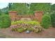 Community entrance sign amidst lush landscaping and colorful flowers, creating a welcoming ambiance at 332 Aster Ridge Trl, Peachtree City, GA 30269