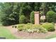 Neighborhood entrance sign surrounded by mature trees, shrubbery and manicured lawn at 332 Aster Ridge Trl, Peachtree City, GA 30269