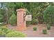 Community entrance sign amidst lush landscaping and colorful flowers, creating a welcoming ambiance at 332 Aster Ridge Trl, Peachtree City, GA 30269