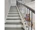 Staircase features white risers, gray treads and a modern wrought iron railing leading to the second floor at 332 Aster Ridge Trl, Peachtree City, GA 30269