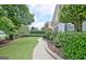 Inviting walkway meanders through a lush green lawn and manicured landscaping at 332 Aster Ridge Trl, Peachtree City, GA 30269