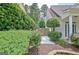 Landscaped yard featuring mature plantings near the front door and side of house at 332 Aster Ridge Trl, Peachtree City, GA 30269