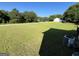 Expansive backyard with lush green lawn, mature trees and an HVAC unit at 116 Cardell Farms Rd, Locust Grove, GA 30248