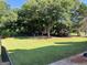 Large, grassy backyard complete with mature trees and a ' playset at 116 Cardell Farms Rd, Locust Grove, GA 30248