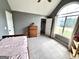 Light-filled bedroom with a vaulted ceiling and large window, plus a walk-in closet at 116 Cardell Farms Rd, Locust Grove, GA 30248