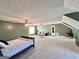 Spacious bonus room with multiple ceiling fans, a seating area, and a bed at 116 Cardell Farms Rd, Locust Grove, GA 30248