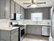 Updated kitchen boasts stainless steel appliances, gray cabinetry, white countertops, and new flooring at 116 Cardell Farms Rd, Locust Grove, GA 30248