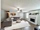 Spacious living room with a decorative fireplace, ceiling fan, and hardwood floors at 116 Cardell Farms Rd, Locust Grove, GA 30248