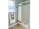 Clean shower with white shower curtain and light coming from the window at 116 Cardell Farms Rd, Locust Grove, GA 30248