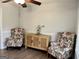 Cozy sitting room featuring a decorative cabinet and matching floral armchairs at 116 Cardell Farms Rd, Locust Grove, GA 30248