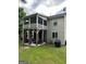 Lovely backyard with two-story screened porch and patio with outdoor seating at 6131 Sparkling Cove Ln, Buford, GA 30518