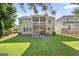 Spacious backyard featuring a well-maintained lawn, a patio, and a screened in porch on the second story at 6131 Sparkling Cove Ln, Buford, GA 30518