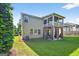 Spacious backyard featuring a well-maintained lawn, a patio, and a screened in porch on the second story at 6131 Sparkling Cove Ln, Buford, GA 30518