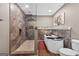 Bathroom with glass-enclosed shower, modern bathtub, and neutral wall tiles at 6131 Sparkling Cove Ln, Buford, GA 30518