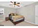 Bedroom featuring a ceiling fan with light, comfortable carpet, a double-door closet, and a queen-sized bed at 6131 Sparkling Cove Ln, Buford, GA 30518