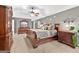 Spacious main bedroom suite featuring a ceiling fan and elegant dark wood furniture at 6131 Sparkling Cove Ln, Buford, GA 30518