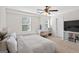 Inviting bedroom with large window, comfortable carpeting, and a ceiling fan at 6131 Sparkling Cove Ln, Buford, GA 30518