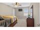 Comfortable bedroom with a window, comfortable carpeting, TV, and ceiling fan with light at 6131 Sparkling Cove Ln, Buford, GA 30518
