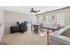 Spacious bonus room with neutral walls, ceiling fan, multiple windows, and built-in bookshelves perfect for a home office at 6131 Sparkling Cove Ln, Buford, GA 30518