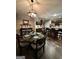 Elegant dining room with stylish chandelier and seamless flow into the kitchen at 6131 Sparkling Cove Ln, Buford, GA 30518