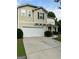 Inviting two-story home with a spacious driveway and covered porch entry at 6131 Sparkling Cove Ln, Buford, GA 30518