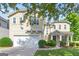 Charming two-story home featuring a well-manicured lawn and an attached two-car garage at 6131 Sparkling Cove Ln, Buford, GA 30518