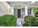 Inviting front porch with stately columns and manicured greenery at 6131 Sparkling Cove Ln, Buford, GA 30518