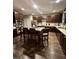 Modern kitchen features stainless steel appliances, dark wood cabinets and large kitchen island at 6131 Sparkling Cove Ln, Buford, GA 30518