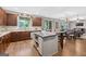 Stylish kitchen with stainless steel appliances, a central island, and an open flow to the living space at 6131 Sparkling Cove Ln, Buford, GA 30518