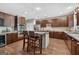 Well-equipped kitchen with stainless steel appliances, a center island, and dark wood cabinets at 6131 Sparkling Cove Ln, Buford, GA 30518