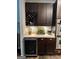 Kitchen area with built-in wine rack and wine refrigerator, stainless appliances at 6131 Sparkling Cove Ln, Buford, GA 30518