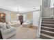 Spacious living room with neutral walls, plush carpet, and staircase at 6131 Sparkling Cove Ln, Buford, GA 30518