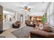 Spacious living room with plush carpet, cozy furniture, and views to the kitchen at 6131 Sparkling Cove Ln, Buford, GA 30518