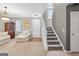 Bright open-concept living area featuring neutral walls and stairs at 6131 Sparkling Cove Ln, Buford, GA 30518
