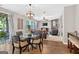 Open-concept living space with dining area, comfortable seating, and a view of the outdoor patio at 6131 Sparkling Cove Ln, Buford, GA 30518