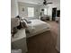 Spacious main bedroom with ample natural light, ceiling fan, walk-in closet, and ensuite vanity at 6131 Sparkling Cove Ln, Buford, GA 30518