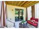 Covered patio with stylish outdoor furniture and sliding glass doors leading indoors at 6131 Sparkling Cove Ln, Buford, GA 30518
