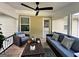 Beautiful open porch with ceiling fan, comfortable seating, and outdoor view at 6131 Sparkling Cove Ln, Buford, GA 30518