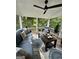 Beautiful screened porch with comfortable seating, ceiling fan, and an open view at 6131 Sparkling Cove Ln, Buford, GA 30518